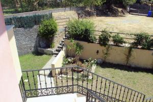 a balcony with a staircase with plants in a yard at I Registi in Scalea