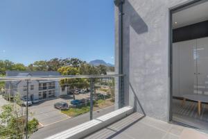an apartment balcony with a view of a building at Trebuchet Studio Apartment in Somerset West
