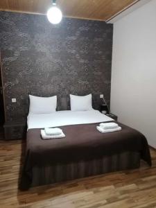 a bedroom with a bed with two towels on it at Hotel Svanseti in Mestia
