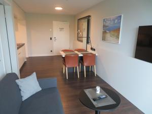a living room with a couch and a table at Hotelapartment Meerliebe in Cuxhaven