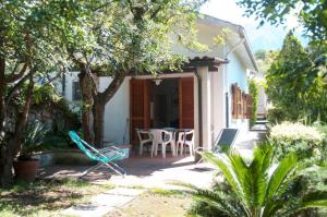 a house with a patio with chairs and a table at Villaglauca in Maratea