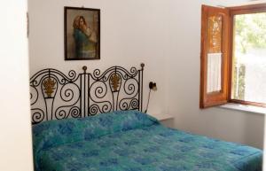 a bedroom with a bed with a blue comforter at Villaglauca in Maratea