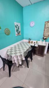 a table in a room with a checkered table cloth at MAR Homestay Seri Iskandar in Seri Iskandar +18 photos