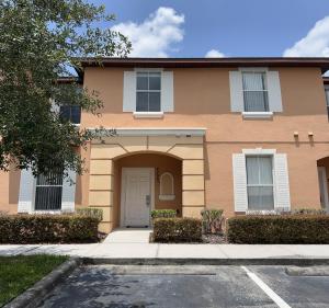 a brown house with a white door at Camaro in Orlando