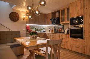 a kitchen with a wooden table and a dining room at Casa do Fasco in Castro Laboreiro