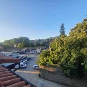 a parking lot with cars parked in it at El Arcángel de Santillana del Mar in Santillana del Mar