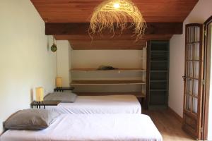 a bedroom with two beds and a chandelier at Yacumama Guesthouse in Soorts-Hossegor