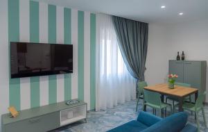 a living room with a blue couch and a table at Maison Matie B&B Ercolano in Ercolano