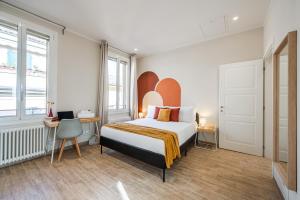 a bedroom with a bed and two windows at Sui Tetti di Bologna centro, Casa Dei Colori in Bologna