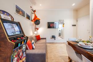 a living room with a video game at Sui Tetti di Bologna centro, Casa Dei Colori in Bologna