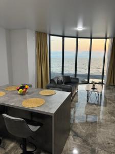 a living room with a table and a couch at Tropical garden apartments in Batumi