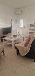 a living room with a bed and a table at The Holiday House in Mavráta
