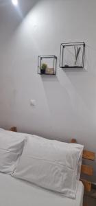 two mirrors on the wall above a bed at The Holiday House in Mavráta