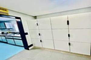 a room with white cabinets and a kitchen with a door at Fantasy Hostel Porto in Porto