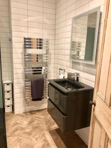a bathroom with a sink and a mirror at Riverside Retreat Sleeps 7 in Cononley
