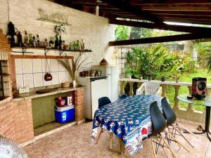 a patio with a table and chairs in a kitchen at Chácara Milk & Shake in Cotia