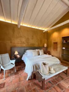 a bedroom with a large bed and a chair at Terrazul Barichara in Barichara