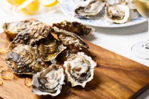 a bunch of oysters on a wooden cutting board at La petite Landaise in Sanguinet