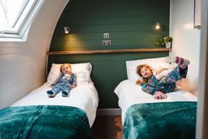 two little girls laying on beds in a room at Fallow Lodge in Little Bytham +43 photos