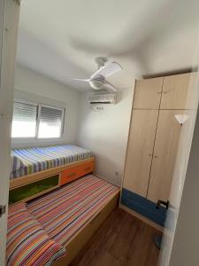 Habitación pequeña con litera y armario en Casita Sol y Mar, en Alicante