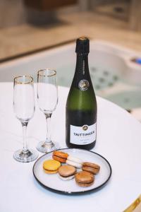 a bottle of wine and two glasses on a table at Centara Spa vichy in Vichy