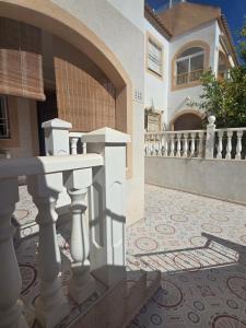 a house with a balcony and a tile floor at Bungalow Brisa de Mar in Torrevieja