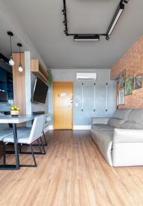 a living room with a couch and a table at PALMAS EXPERIENCE - APARTAMENTO CONTEMPORÂNEO, vista serra, na quadra do shopping in Palmas