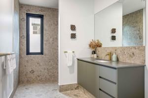 a bathroom with a sink and a mirror at Birdnest Kookaburra in Witchcliffe +33 photos