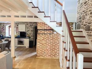 a staircase in a house with a brick wall at Dreamy Cottage in Ayiá