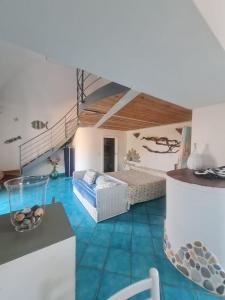 a living room with a bed and a couch and a table at Le Case dei Pescatori - Mare Blu in Ponza
