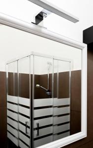 a glass cabinet with a light on top at Fatata Suites in Lecce +154 photos