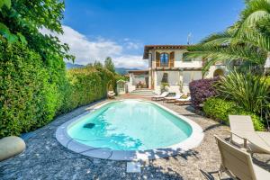 a swimming pool in front of a house at Villa Lorenzo in Querceta