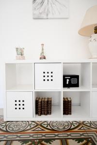 a living room with white shelves and a rug at Fatata Suites in Lecce