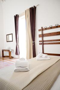 a bedroom with a bed with two towels on it at Fatata Suites in Lecce