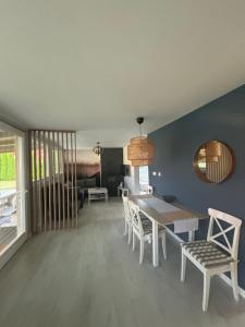 a dining room with a table and chairs at ARKANA Rydzewo in Rydzewo
