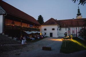 a group of people sitting outside of a building at Rezidenca Sv. Peter in Malečnik