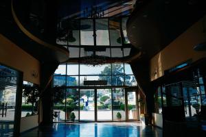an empty lobby with a large glass window and a building at Fabryka Jedzenia in Zambrów