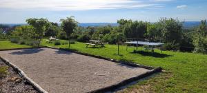 a park with a ping pong table and a picnic table at Le petit nid du Quercy in Anglars-Nozac