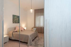 a bedroom with a bed and a mirror at Casa Giulia in Castellammare di Stabia