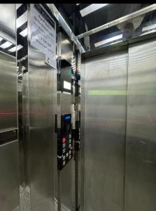 a metal elevator in a subway train with a sign on it at Apartment - "exclusive" in Tbilisi City