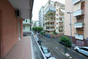 a view of a city street with parked cars on a balcony at Casa Giulia in Castellammare di Stabia