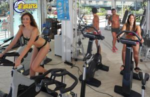 two women riding on exercise bikes in a gym at Hotel Chic in Cattolica