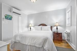 a white bedroom with a large bed with white sheets at Villa Mulvey #2 in Saint Augustine +18 photos