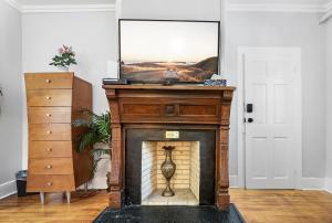 a fireplace in a living room with a painting on top at Villa Mulvey #2 in Saint Augustine