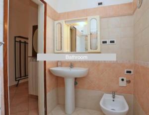 a bathroom with a sink and a mirror at Casa Blu di Pomposa Vista Mare in Lido di Pomposa +32 photos