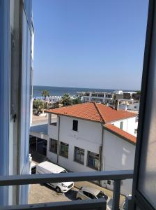 a balcony with a view of a building and the ocean at Casa Blu di Pomposa Vista Mare in Lido di Pomposa