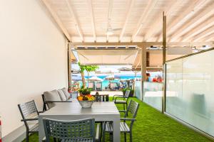 a table and chairs on a patio with a view of the ocean at Kima Premium Apartments in Pefkohori
