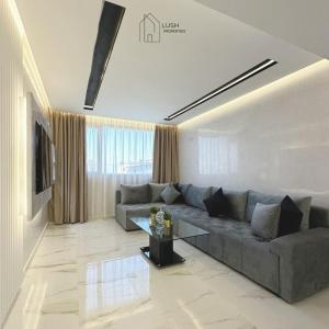a living room with a couch and a table at LUXURY Hilton City Center residence 5A GUEST FRIENDLY in Tangier +8 photos