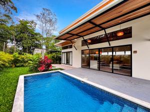a swimming pool in front of a house at Villa Julio in Puerto Viejo