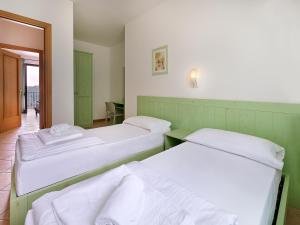 Postel nebo postele na pokoji v ubytování Residence Besass, GTSGroup